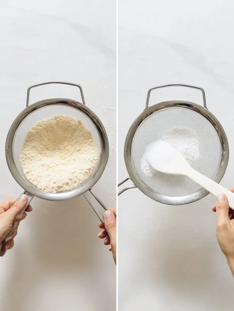 “Two baking sheets lined with parchment paper, ready for piping strawberry macaron shells.”